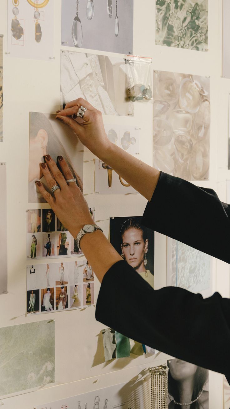 Hands pinning images to a moodboard
